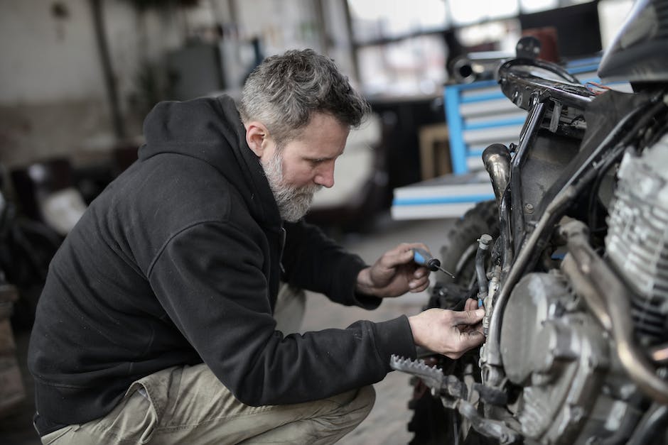 Image of a person performing maintenance on a motorcycle